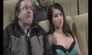 Busty Teen groped beside Dad by strangers in a large screen hall